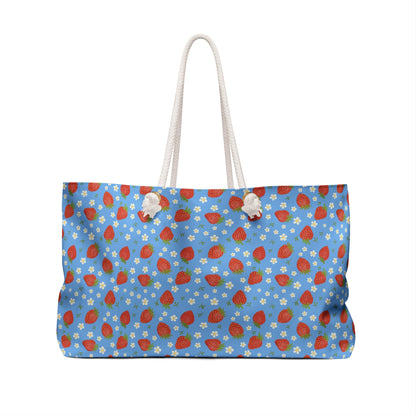 Weekender Bag with Strawberry Design: A stylish accessory featuring strawberries and white flowers, perfect for travel. With rope handles and ample storage, it combines convenience and a cheerful, fruit-themed aesthetic.