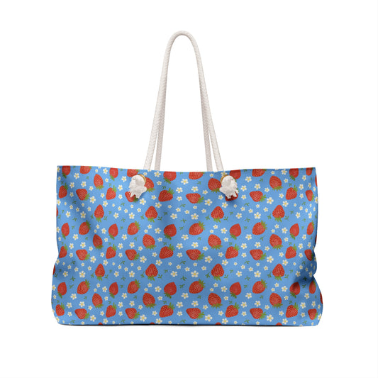 Weekender Bag with Strawberry Design: A stylish accessory featuring strawberries and white flowers, perfect for travel. With rope handles and ample storage, it combines convenience and a cheerful, fruit-themed aesthetic.