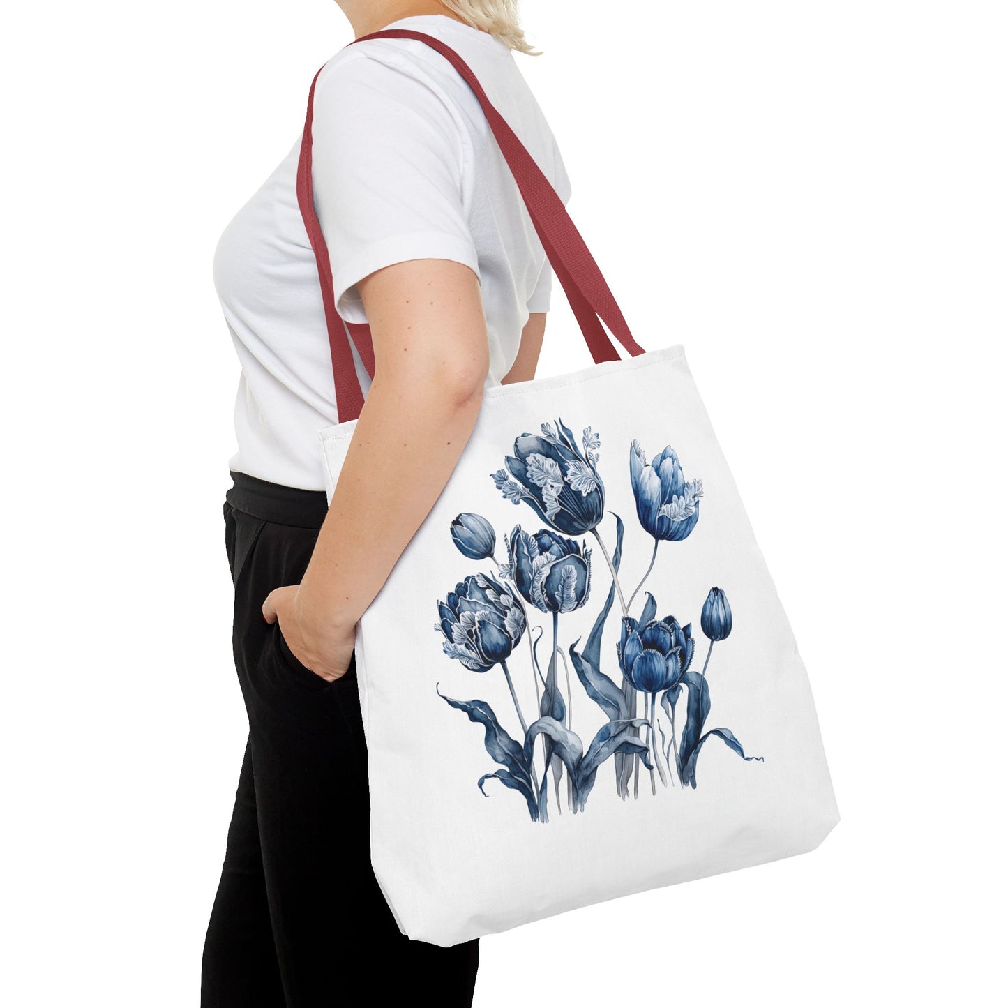 Flowers in Blue Hue Watercolor Tote Bag held by a woman, showcasing its floral design. Ideal for stylish functionality in daily errands and outdoor adventures.