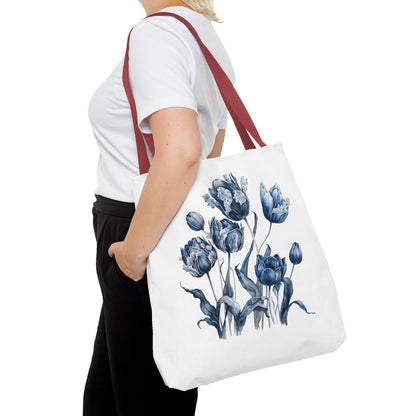 Flowers in Blue Hue Watercolor Tote Bag held by a woman, showcasing its floral design. Ideal for stylish functionality in daily errands and outdoor adventures.