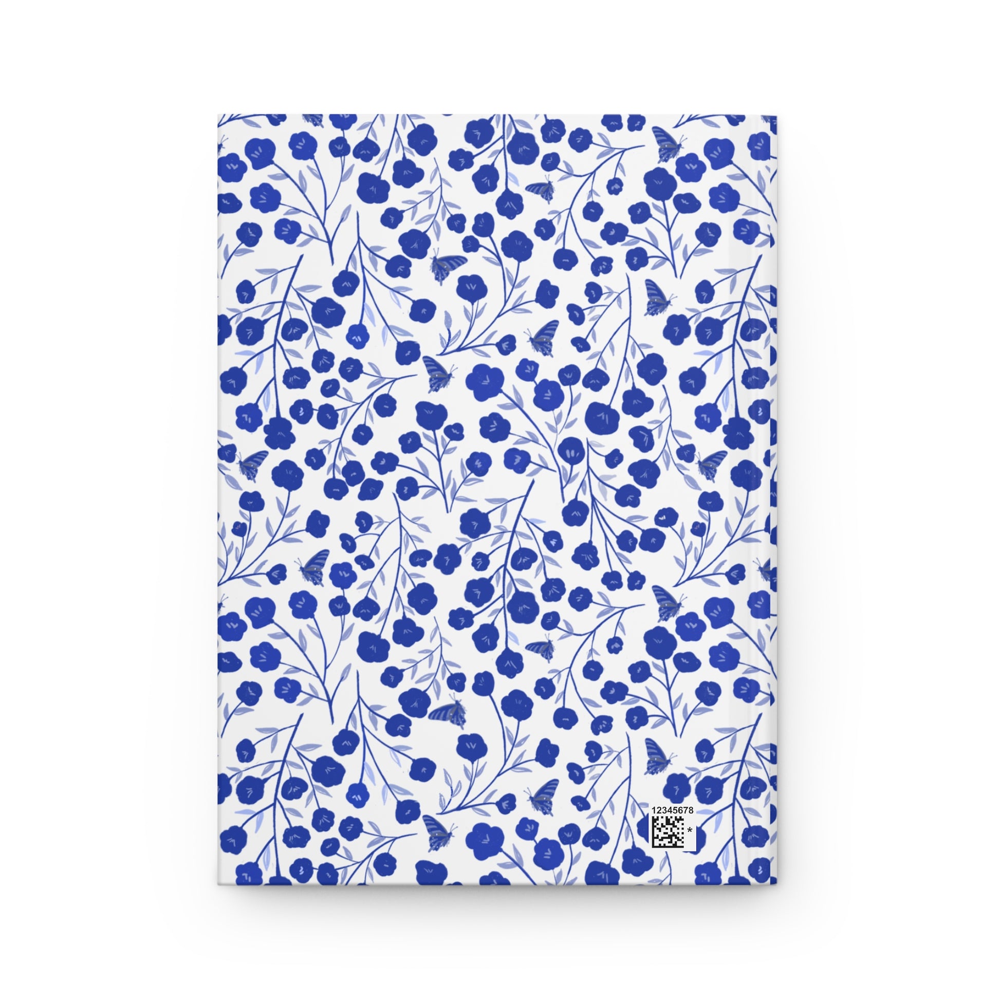 HARDCOVER JOURNAL, MATTE, RULED, 5X7, SEWN BIND, CLEAN-TEAR PAGES – INDIGO PETALS features a cobalt blue floral pattern with butterflies on a white background, with a matte laminated cover and sewn binding.