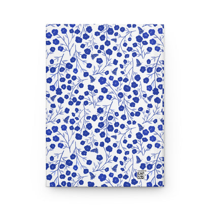 HARDCOVER JOURNAL, MATTE, RULED, 5X7, SEWN BIND, CLEAN-TEAR PAGES – INDIGO PETALS features a cobalt blue floral pattern with butterflies on a white background, with a matte laminated cover and sewn binding.