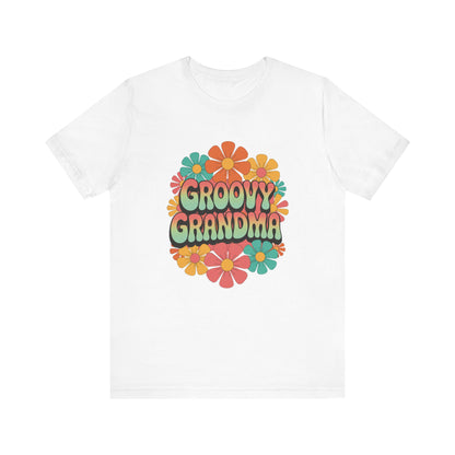 Groovy Grandma for Mother's Day Bella+Canvas Unisex T-Shirt features a colorful floral design, combining retro charm with modern comfort, aligning with FireBrook Essentials' mission of uplifting, stylish apparel.