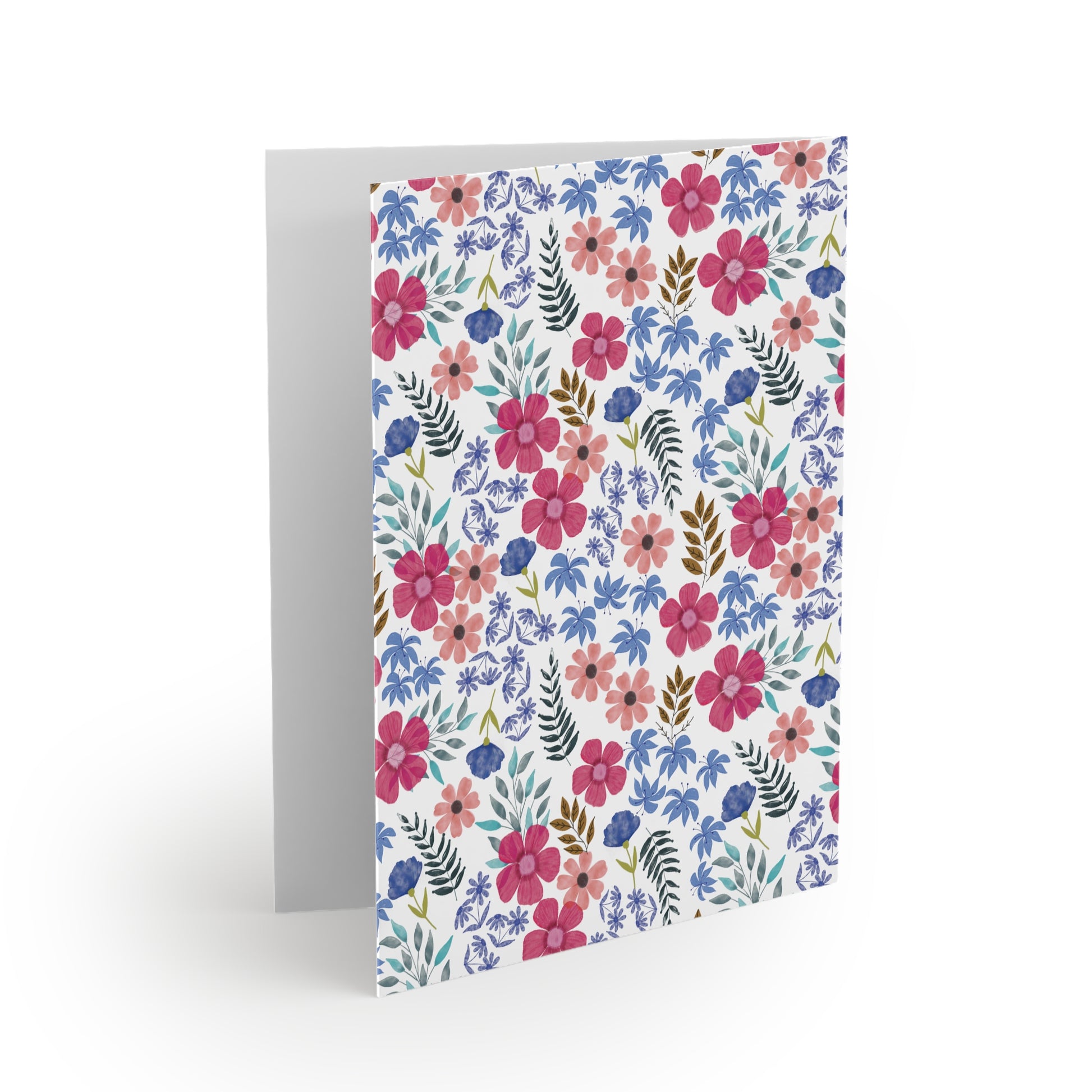Floral Wildflower Greeting Cards feature a vibrant watercolor-style floral pattern with pink, mauve, and blue blossoms, perfect for adding a touch of springtime joy to your messages.