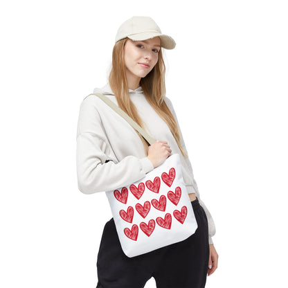 Hearts Tote Bag showcased with a woman holding a white bag adorned with red hearts, embodying FireBrook Essentials' uplifting, stylish design ethos. Perfect for adding a playful touch to any outfit.