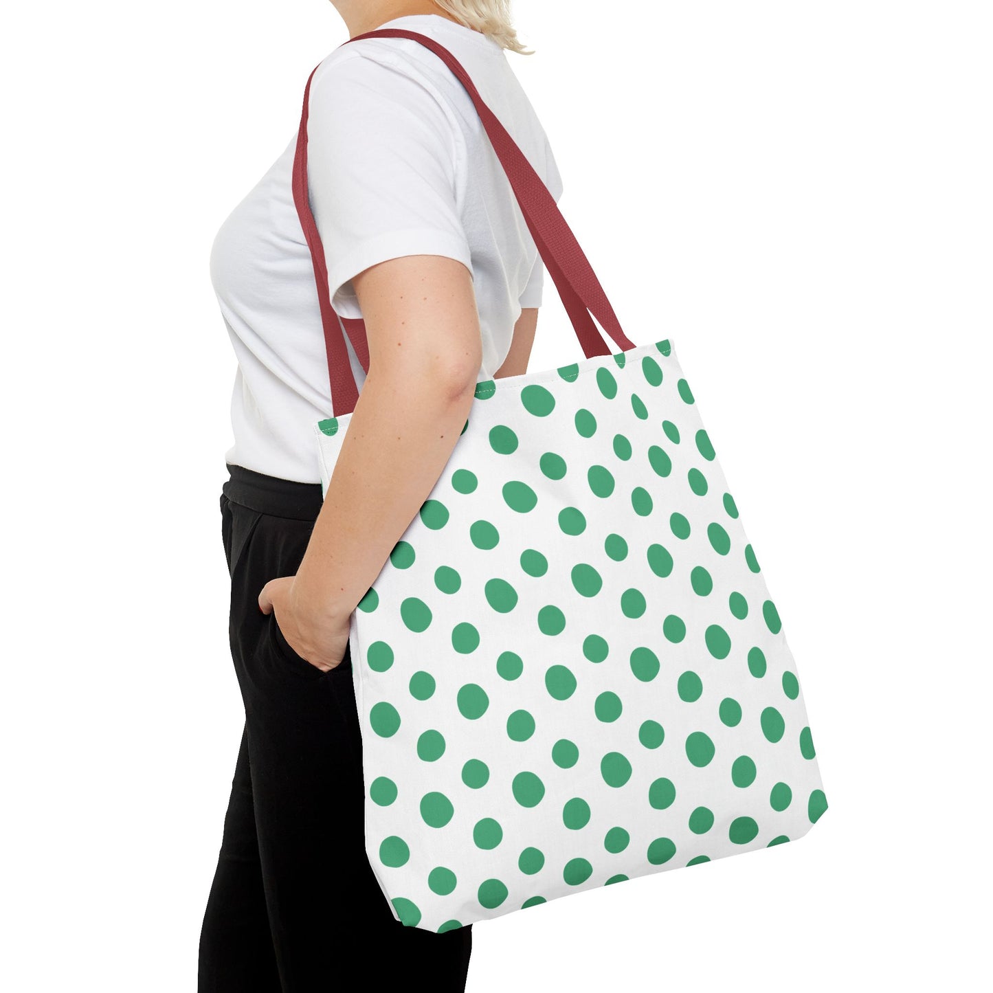 Green Polka Dots Tote Bag with green and white polka dot pattern, held by a woman, showcasing its playful design and reinforced handles, ideal for adding color to everyday outfits.