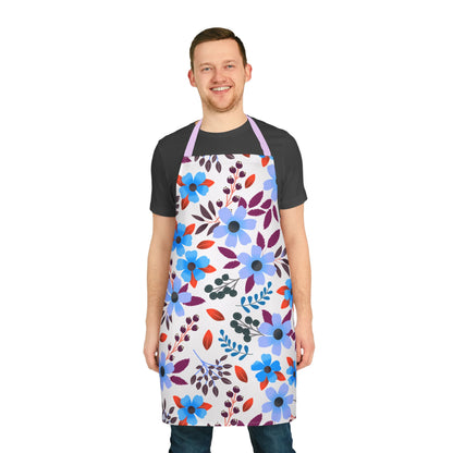 Young man models a stylish Floral Apron, featuring vibrant blue and lavender blossoms, ideal for baking or crafting. Its soft, stain-free polyester canvas enhances comfort while showcasing FireBrook Designs' uplifting, joyful style.