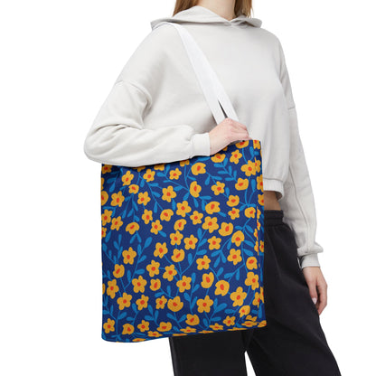 Cobalt Poppy Field Tote Bag features a vibrant blue canvas with yellow-orange floral patterns, plain white straps, perfect for cheerful summer outings. Ideal for style and durability from FireBrook Designs.