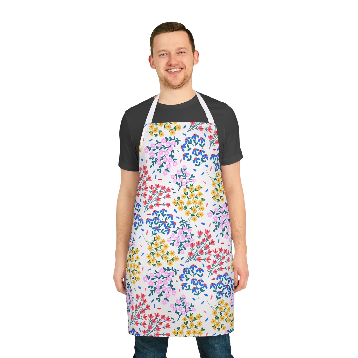 A man wears FireBrook Designs' Floral Apron, showcasing vibrant floral patterns. The apron, with white straps, complements his dark attire, embodying comfort and style for various activities.