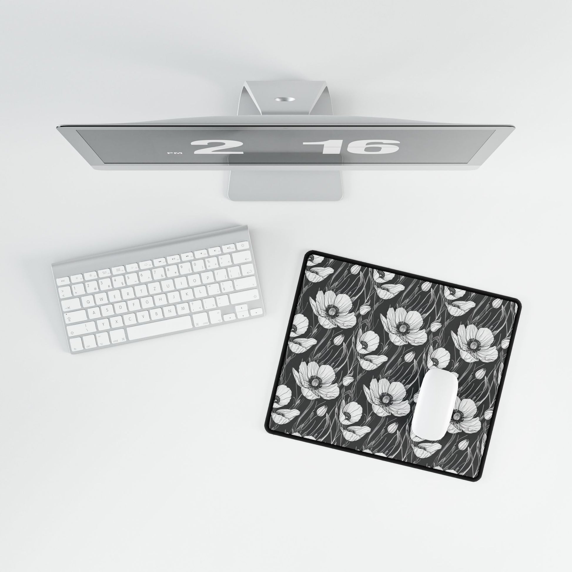 Monochrome Poppies Floral Desk Mat features intricate poppy line art on a keyboard, enhancing workspace aesthetics with its minimalist style, perfect for gifting and adding elegance to any desk setting.