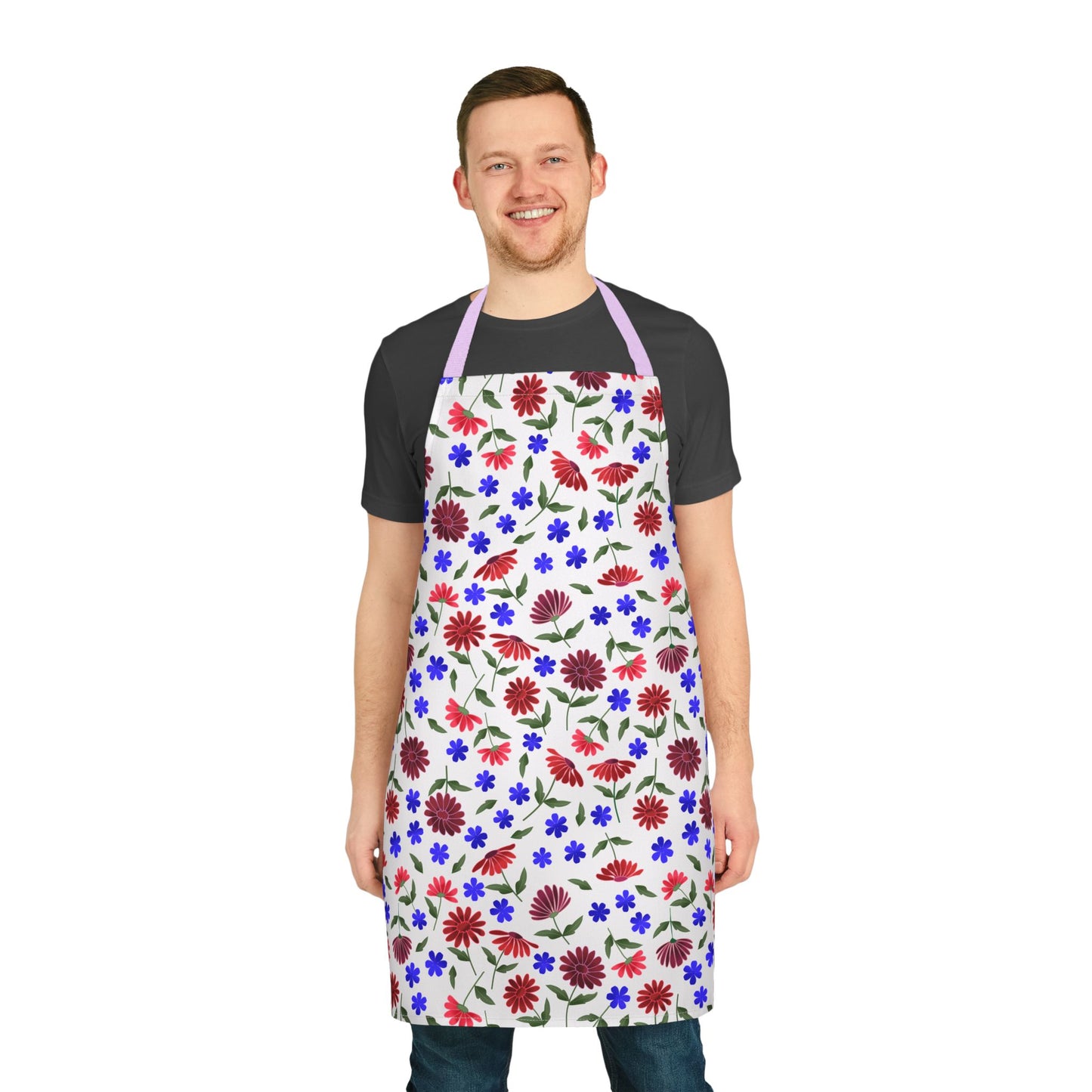 Floral Apron: A smiling man wears a white apron with vibrant red, blue, and purple floral patterns. Ideal for various activities, the apron features a light purple neck strap, emphasizing comfort and style.