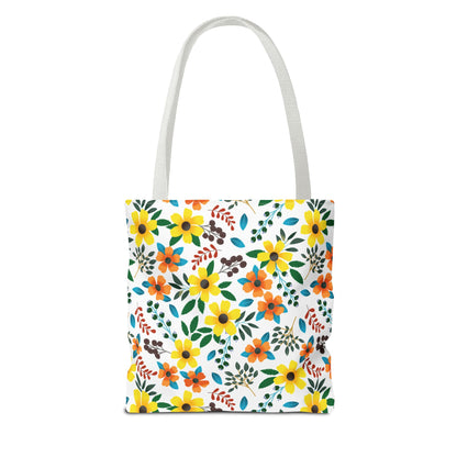 Sunny Meadow Mix Tote Bag featuring vibrant yellow and orange daisy-like flowers with green leaves and berry clusters on a white canvas-style body, complemented by sturdy white handles, perfect for cheerful summer outings.