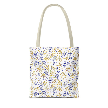 Wild Herb Garden Tote Bag features a white background with blue and gold botanical motifs, complemented by natural handles. Perfect for summer outings, offering durability and style from FireBrook Designs.