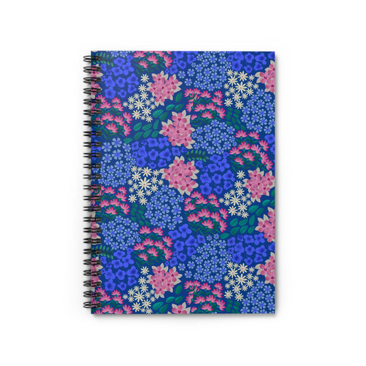 Floral Spiral Notebook with vibrant pink blossoms and green leaves on a blue cover, featuring a black spiral binding. Ideal for creative note-taking, reflecting FireBrook Designs' uplifting aesthetic.