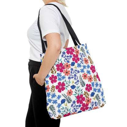 Person wearing white T-shirt and black pants carries a Confetti Wildflower Tote Bag, featuring bright floral print on a white background, embodying FireBrook Designs' cheerful, uplifting style.