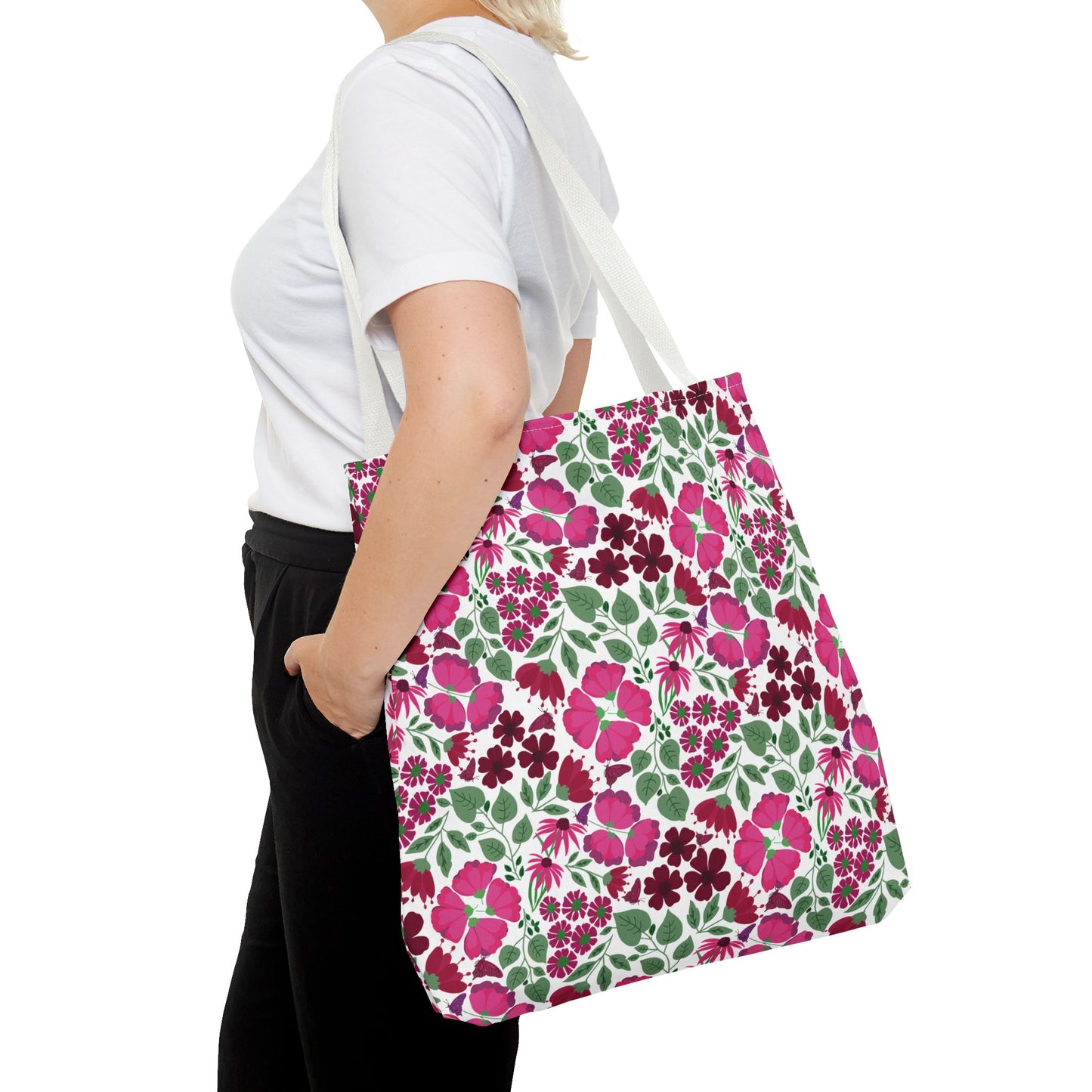 Pink Lady Tote Bag with vibrant pink and magenta floral pattern against white, draped over shoulder. Ideal for adding a pop of color, perfect for daily essentials or gifting.
