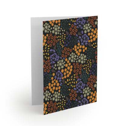 Floral Greeting Cards — Pack of 8/16/24: A folded card with a dense floral pattern in rust-orange, cream, and purple, set against a dark background, perfect for personal messages. Includes matching white envelope.
