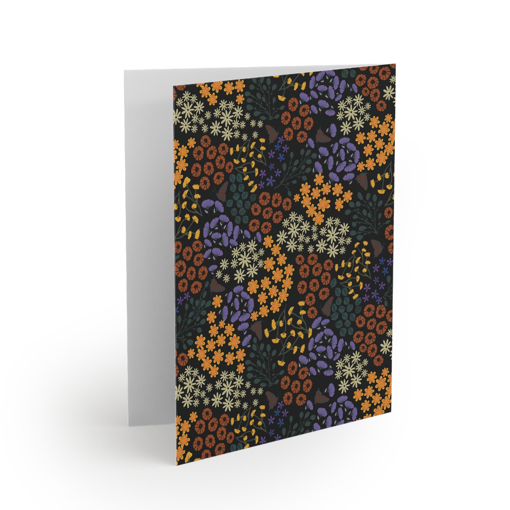 Floral Greeting Cards — Pack of 8/16/24, featuring vibrant dark-background floral patterns with orange, cream, and purple blossoms. The card is folded open, showcasing its blank interior, ready for personalized messages.