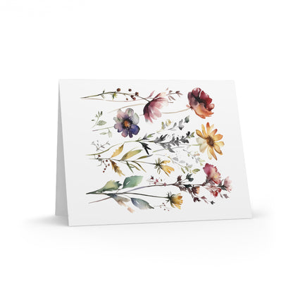 Flower Greeting Cards — Pack of 8/16/24 feature watercolor-style botanical illustrations with wildflowers and leafy sprigs on a matte-finish card, perfect for personal messages. Includes matching white envelopes.