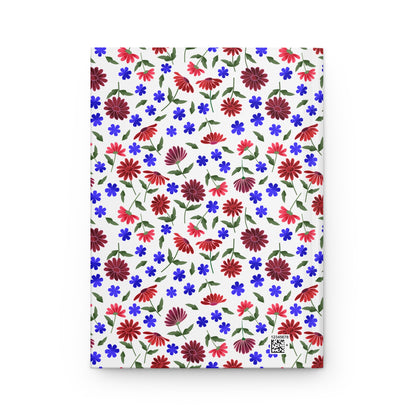Floral Ditsy Hardcover Journal — Red & Blue Wildflower Notebook features a vibrant floral pattern of red daisies and blue blossoms on a white matte cover, embodying FireBrook Designs' uplifting style.