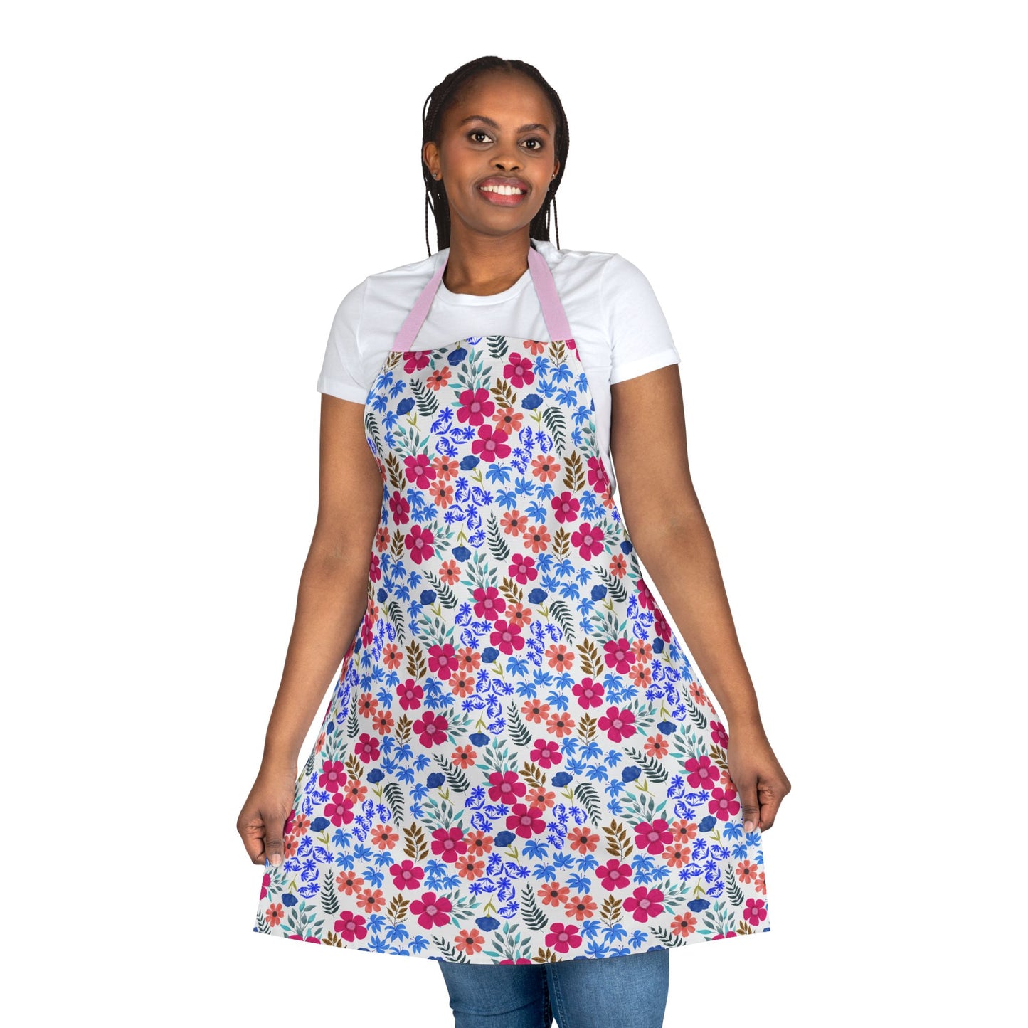 Woman wearing Apron Floral Design, featuring vibrant multicolored flowers and pink straps. Ideal for home activities, this apron combines style and practicality. Made from soft, stain-free polyester canvas for comfort.