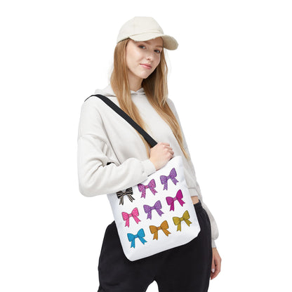 Woman holding a stylish Bows Ribbons Tote Bag, featuring bow prints, ideal for fashion lovers seeking a practical, playful addition to their everyday outfits.