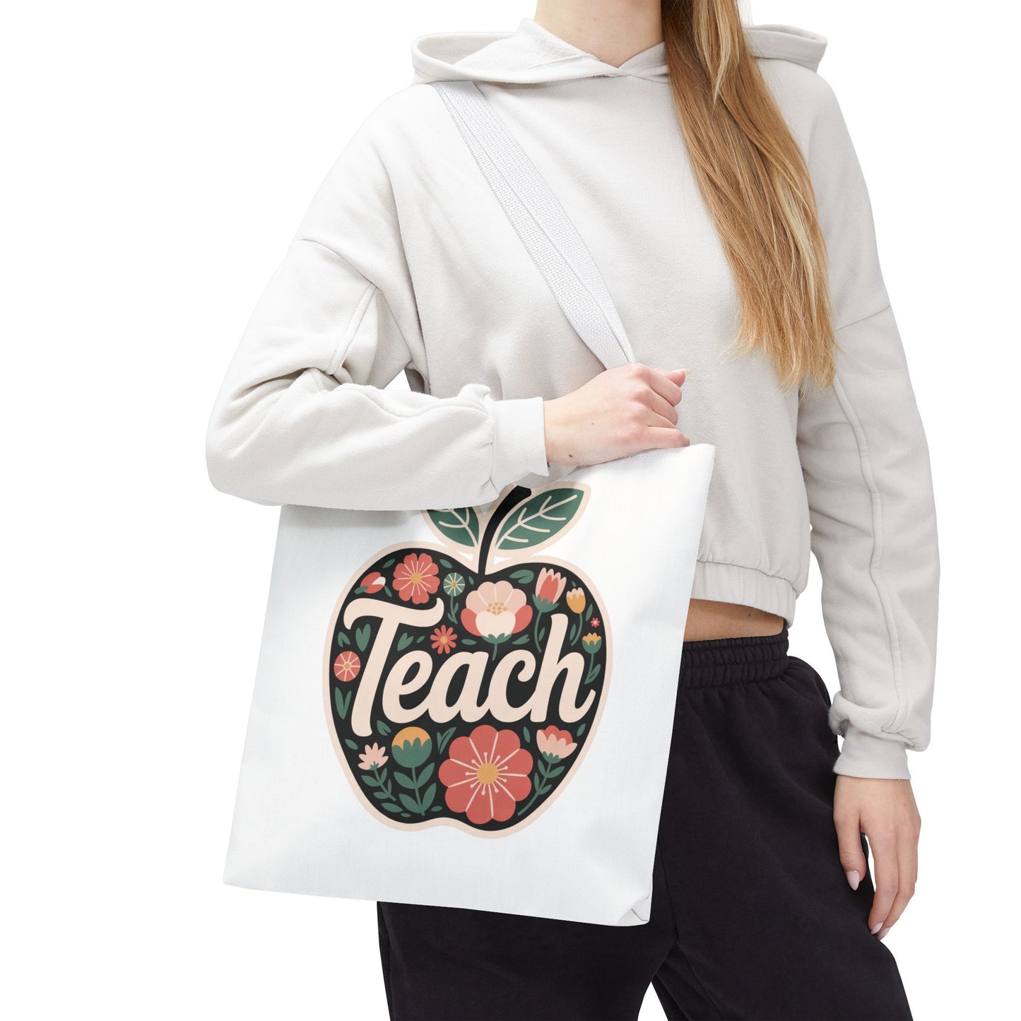 Floral Apple Tote Bag - Hand-Drawn Pastel-Colored Design with 'TEACH', showcasing a cheerful apple shape filled with floral illustrations, ideal for educators. Durable polyester body with reinforced handles, available in multiple sizes.