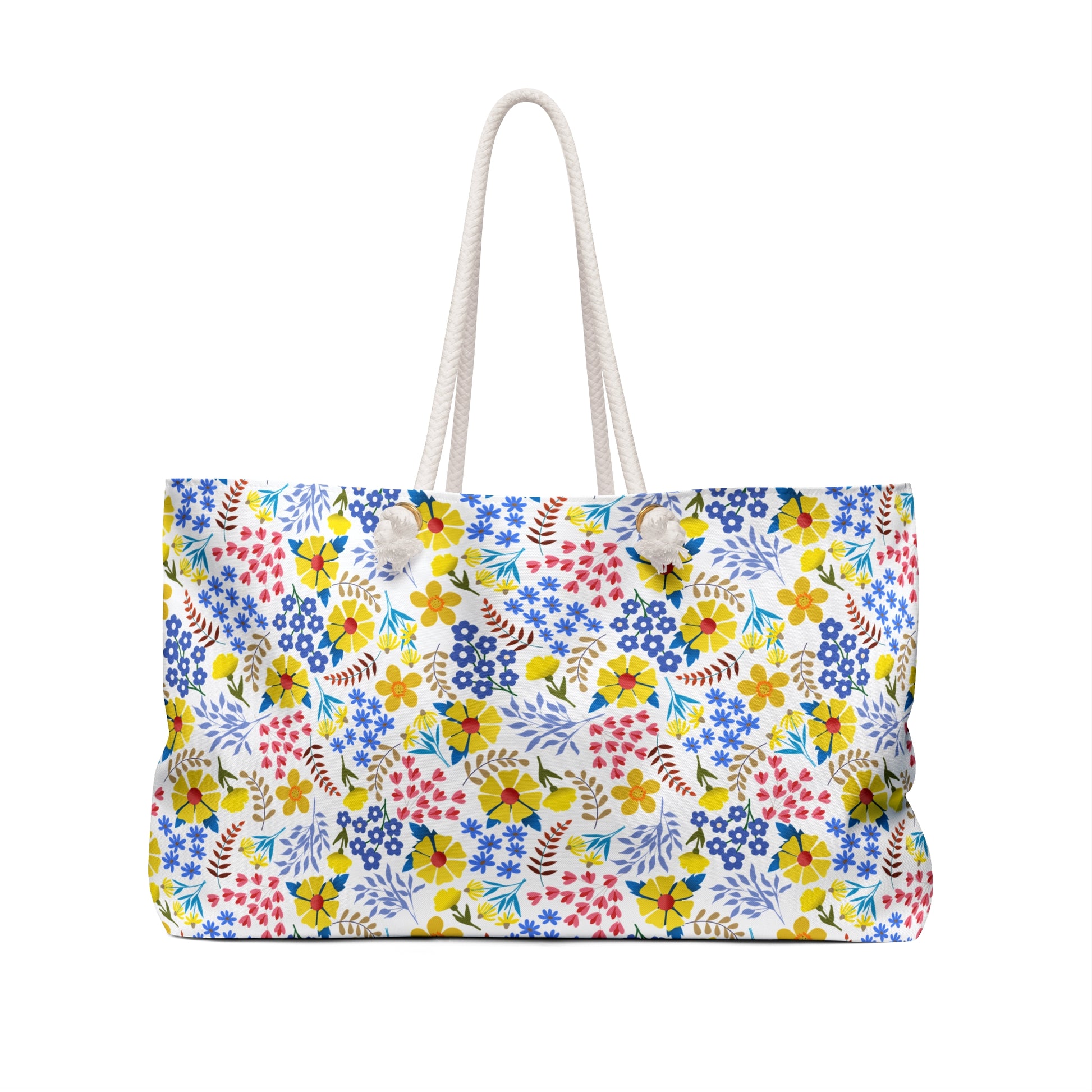 Weekender Bag with colorful floral print on white canvas, featuring thick rope handles. Ideal for stylish weekend getaways, this bag from FireBrook Essentials adds a vibrant touch to your travels.