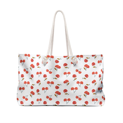 Cherry Weekender Bag with a playful red cherry pattern, featuring chic cream-colored rope handles. Spacious and durable, perfect for stylish summer getaways or as a delightful gift.