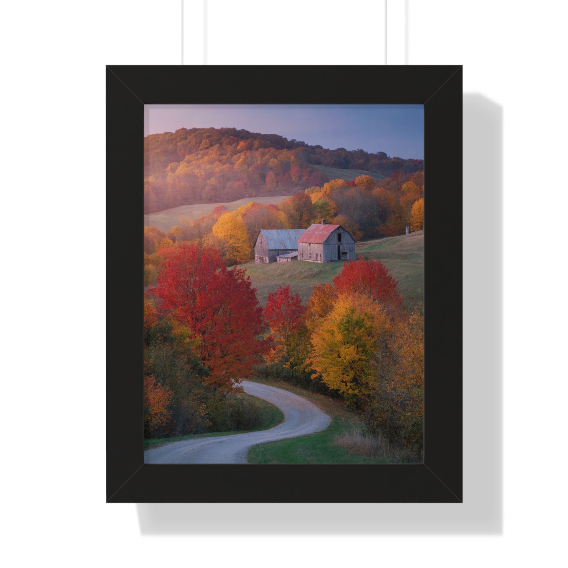 Vertical Poster - Countryside Fall Foliage Photography: A framed poster showcasing a serene countryside scene with a barn, red-leafed trees, and a winding road, capturing the vibrant essence of autumn.