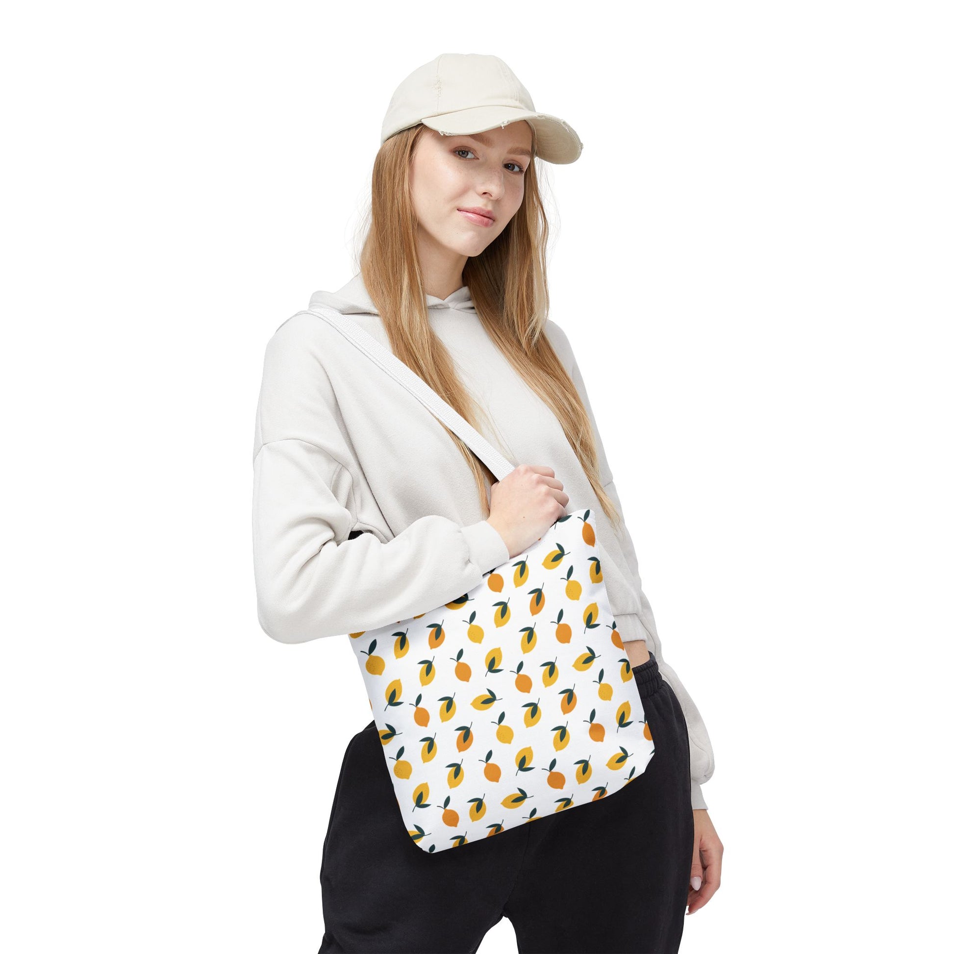 Young woman casually holds the Lemon Tote Bag - Fresh and Fun Citrus Pattern, featuring vibrant stylized citrus fruits, embodying FireBrook Essentials' joyful and uplifting design ethos for stylish, everyday use.