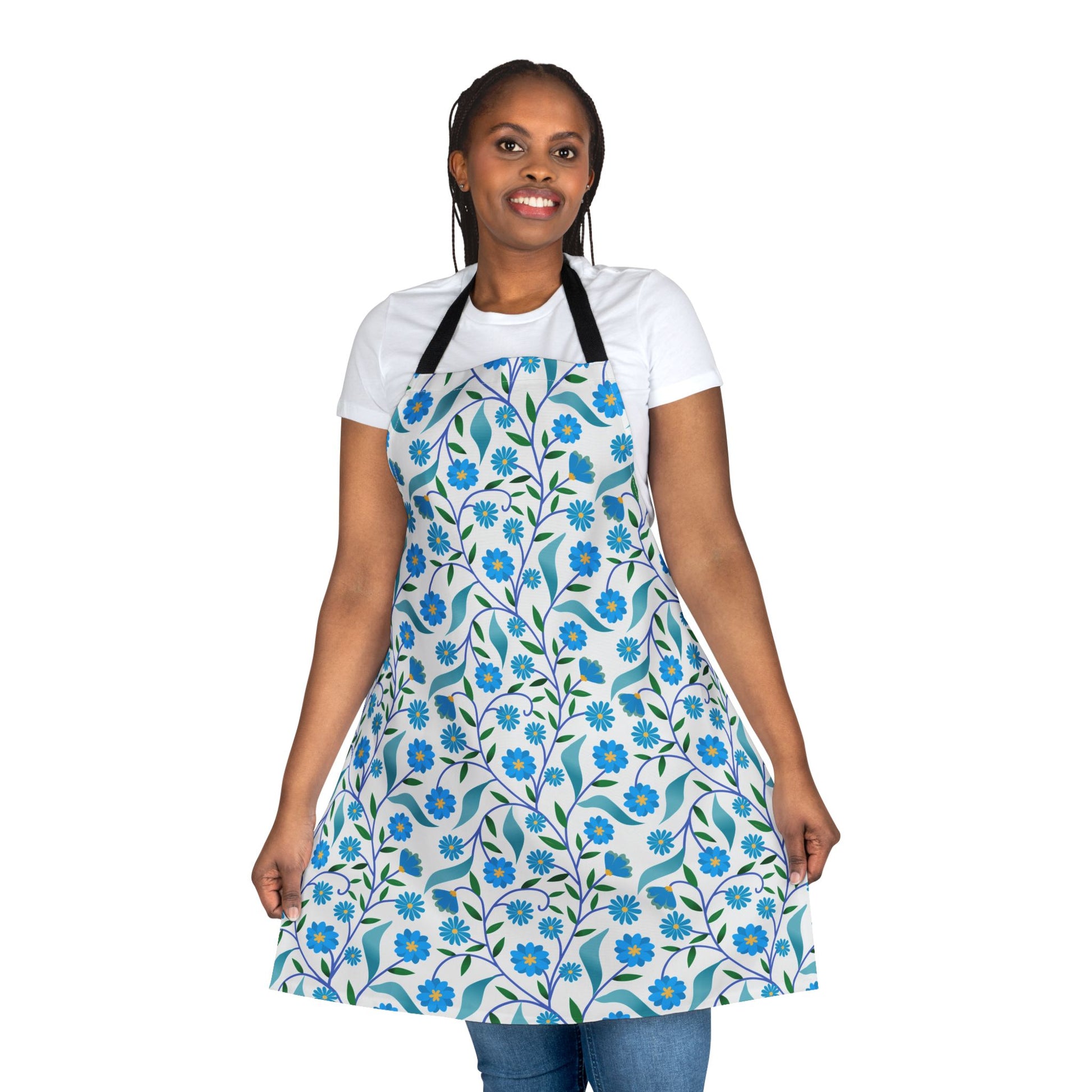 Model wearing Apron Floral Design with blue flowers and green leaves pattern, showcasing its full coverage over a white T-shirt and jeans, perfect for stylish, comfortable kitchen wear.