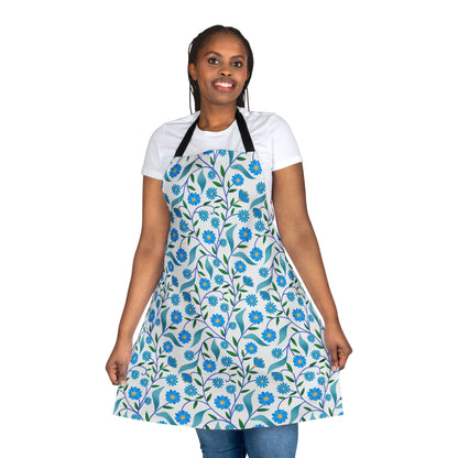 Model wearing Apron Floral Design with blue flowers and green leaves pattern, showcasing its full coverage over a white T-shirt and jeans, perfect for stylish, comfortable kitchen wear.