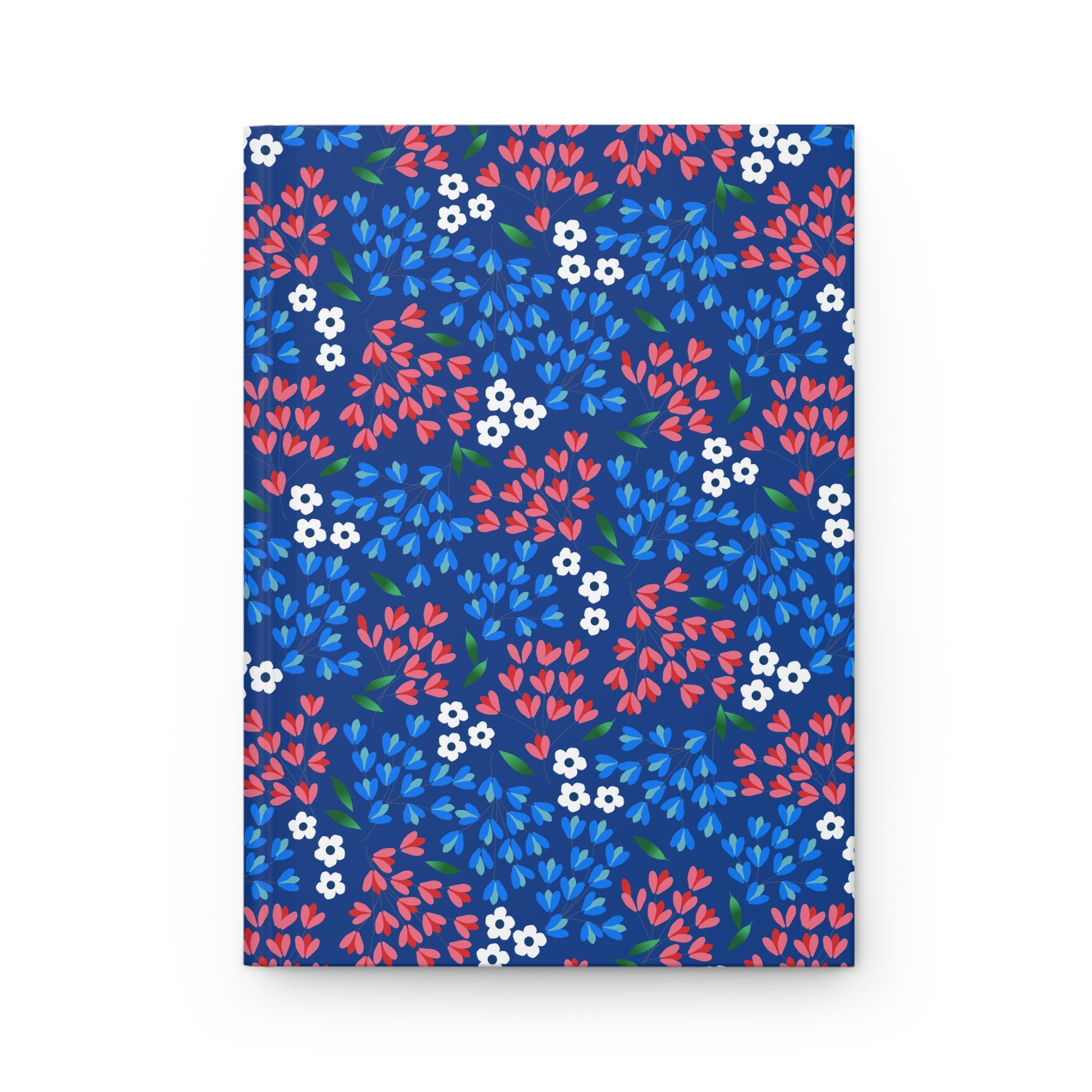 HARDCOVER JOURNAL, MATTE, RULED, 5X7, SEWN BIND, CLEAN-TEAR PAGES – WILDFLOWER SKY features a navy cover with vibrant coral, sky-blue petals, white flowers, and green leaves in a seamless floral pattern.