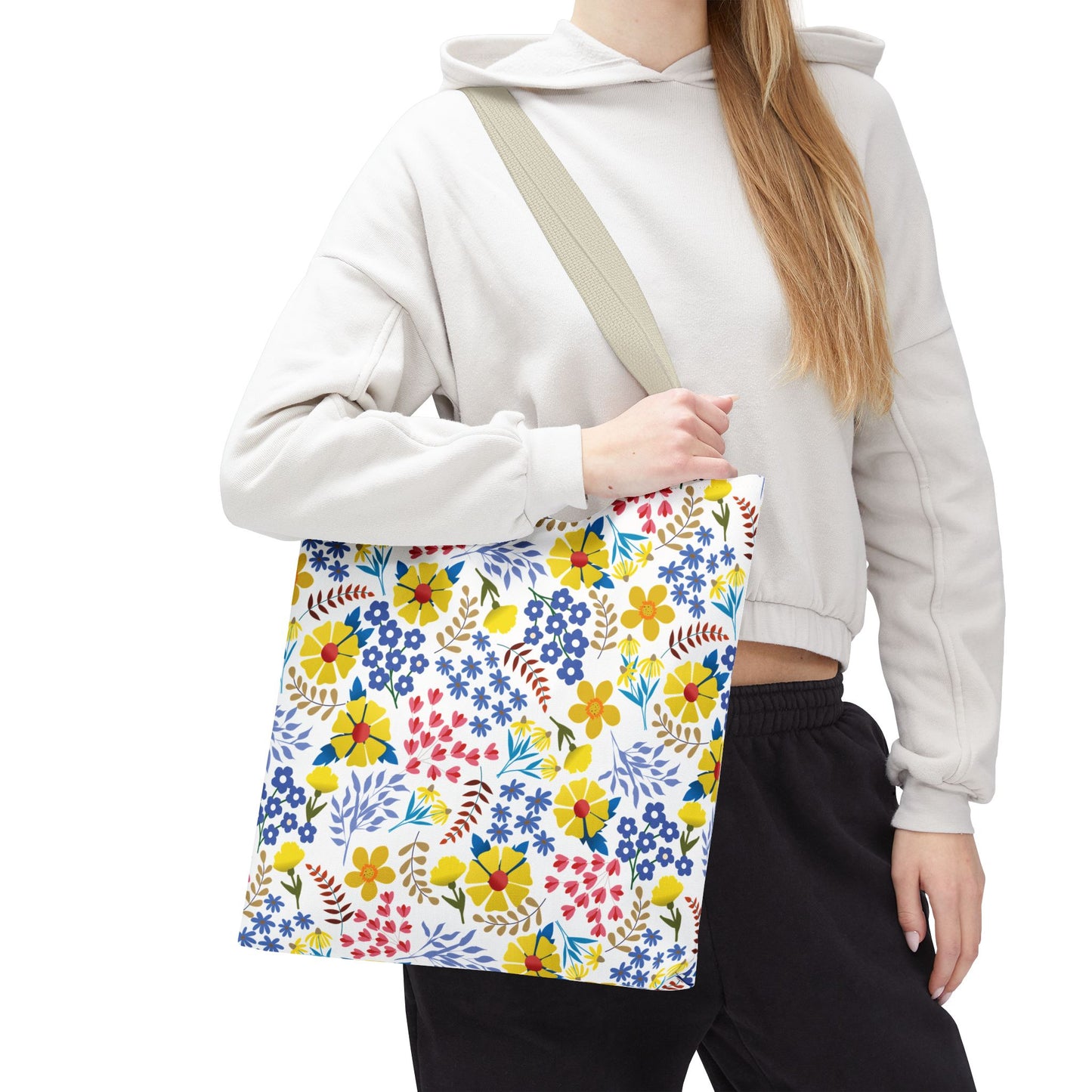 Floral Tote Bag with vibrant yellow, red, and blue floral patterns, carried over the shoulder. Perfect for summer outings, reflecting FireBrook Designs' commitment to joyful, stylish essentials.