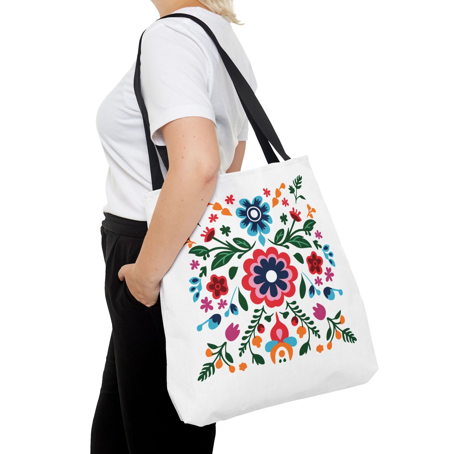 Floral Tote Bag: A woman holds a stylish white tote with a vibrant flower design, perfect for daily use and errands.