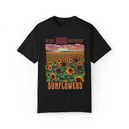 The 'Be the Rose in a Field of Sunflowers T-shirt' features an uplifting quote, double-needle stitching, and garment-dyed softness, exemplifying FireBrook Essentials' commitment to comfort and positivity in everyday wear.