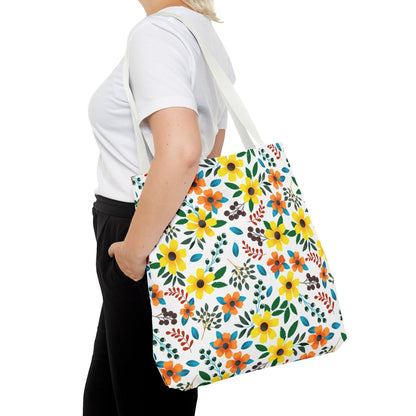 Person carrying the Sunny Meadow Mix Tote Bag, featuring a vibrant floral pattern with large yellow and orange blooms, green leaves, and berry-like accents, ideal for brightening up any summer outing.