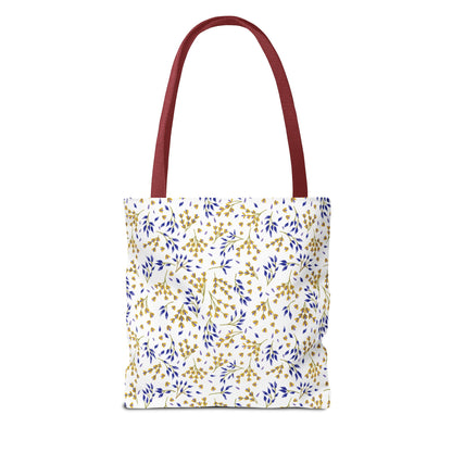 Wild Herb Garden Tote Bag features a white canvas body with a blue and gold botanical pattern and reddish-maroon straps, perfect for summer outings and embodying FireBrook Designs' uplifting style.