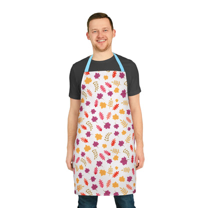 Smiling man models the Apron Floral Design, adorned with vibrant autumn leaves, featuring light blue straps. This stain-free, soft polyester apron offers comfort and style, perfect for joyful cooking or crafting.