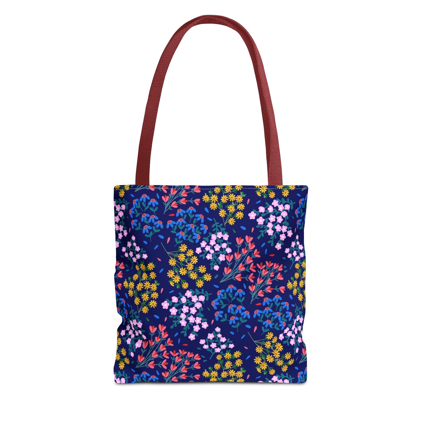 Midnight Garden Tote Bag showcases a dark navy-blue body with a vibrant floral pattern, featuring clusters of blooms in various colors. It has sturdy, flat shoulder straps in reddish-maroon.