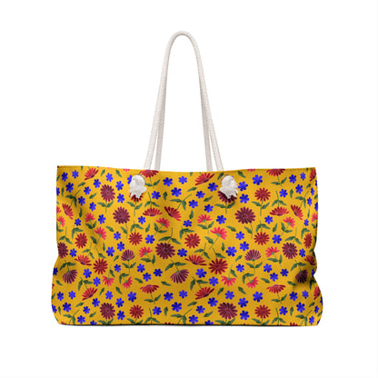 Yellow Floral Weekender Bag — Bright Boho Travel Tote with vibrant floral patterns on yellow canvas, features soft cream rope handles through grommets and a structured T-bottom, embodying FireBrook Designs' joyful style.