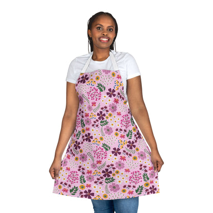 Person modeling the Floral Apron from FireBrook Designs, featuring colorful floral patterns, shoulder straps, and a tie-back closure, designed for comfort and style in various activities.