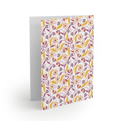 Floral Greeting Cards — Pack of 8/16/24 showcasing a vibrant floral pattern on matte cardstock, suitable for personal messages. The card stands upright, blank inside, with a matching white envelope included.