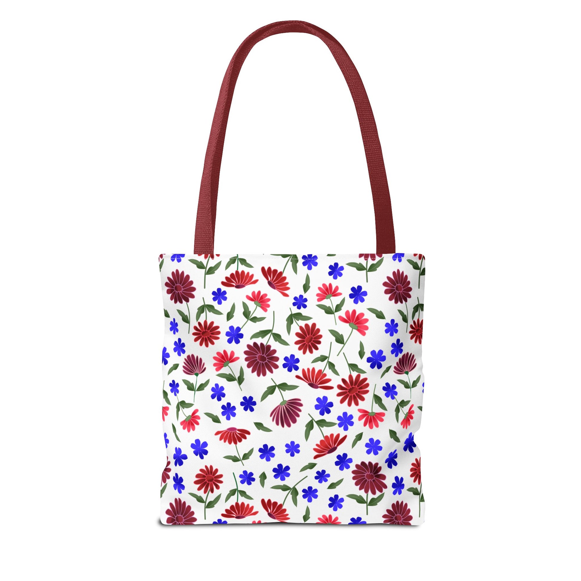 Floral Pattern Tote Bag — Red & Blue Wildflower All-Over Print features a white canvas-style tote with vibrant red daisies and blue blooms, complemented by deep red handles, embodying FireBrook Designs' joyful, uplifting style.
