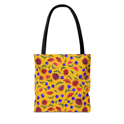 Golden Wildflower Tote Bag with vibrant floral pattern; features red-orange daisies and blue flowers on a yellow background. Durable with black straps, ideal for everyday errands.