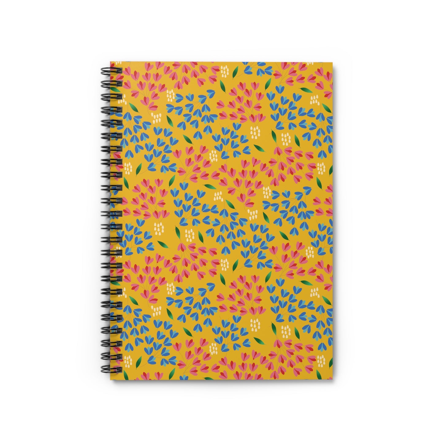 Floral Spiral Notebook featuring a mustard-yellow cover with a vibrant, repeating floral pattern of pink and blue teardrop petals, green leaves, and white dots, ideal for creative journaling and note-taking.