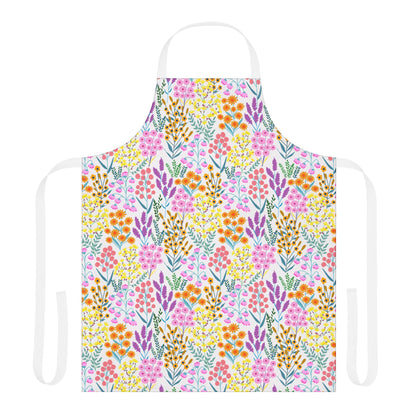 Floral Apron features a vibrant wildflower pattern in pink, orange, yellow, purple, and teal on a white polyester canvas. It includes a white neck loop and waist ties for a cheerful, stylish look.