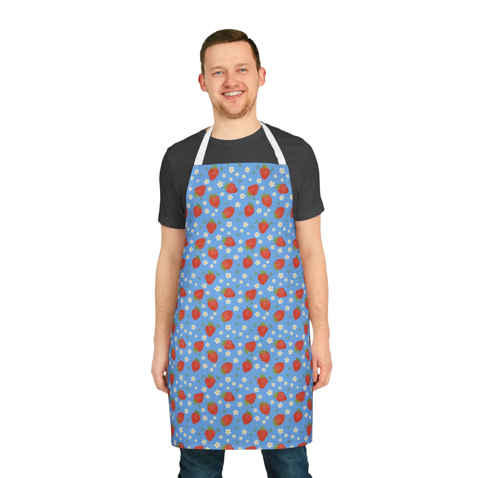 Man smiling while wearing the Apron, Strawberry 5-Color Straps, showcasing its vibrant strawberry design and adjustable fit, ideal for cooking and crafting, from FireBrook Designs' uplifting and stylish collection.