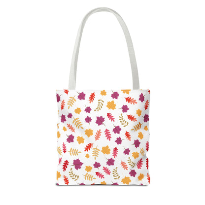 Autumn Leaves Tote Bag featuring a vibrant pattern of scattered autumn-style leaves in orange, gold, red, and purple on a white canvas, ideal for stylishly carrying everyday essentials.